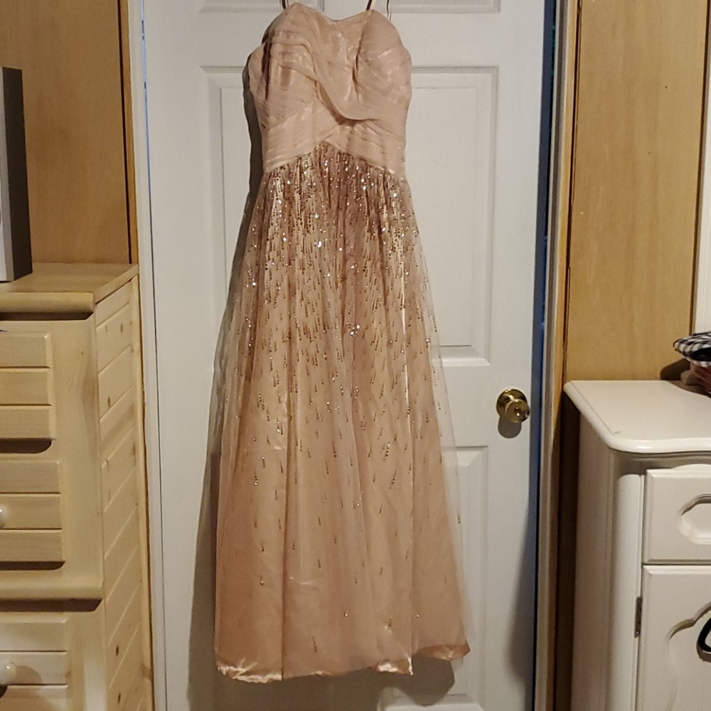 Strapless peach colored Hailey Logan prom dress